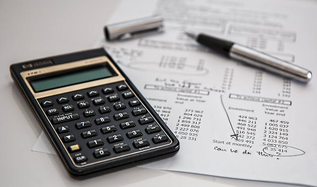 a calculator and a financial document