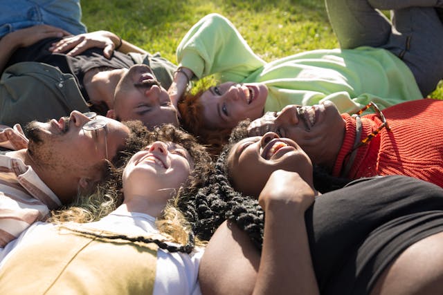 people laying on grass
