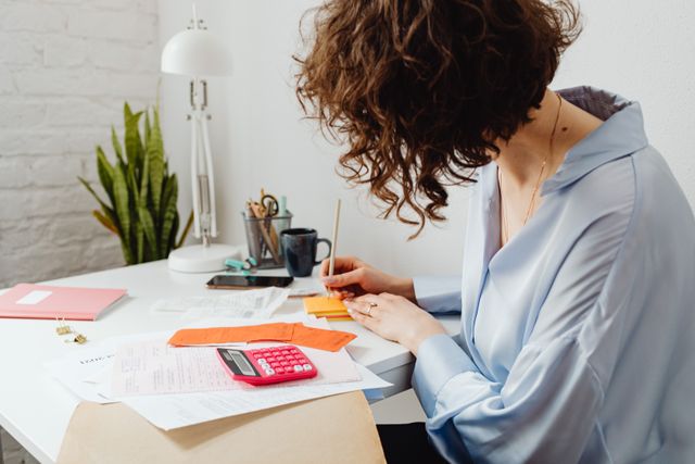person at a desk managing paperwork