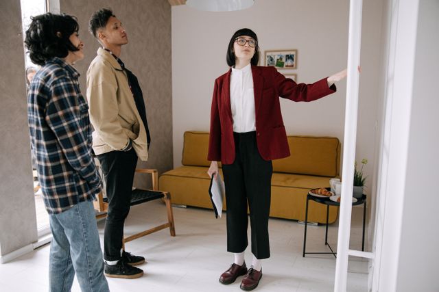 person showing two people a property interior