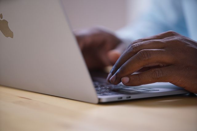 person using a laptop at a desk